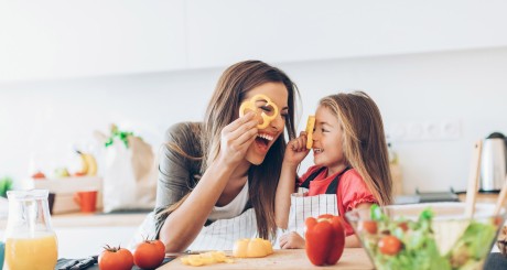 a young woman and her daughter eating breakfast