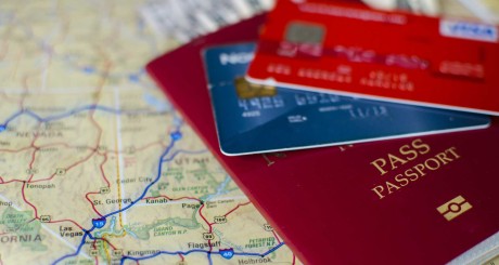 several credit cards and a passport stacked on a map