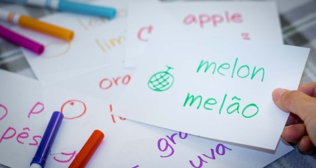 a child writing flashcards in Spanish and English
