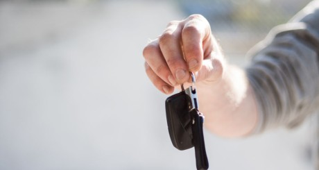 a driver holding their car keys in their outstretched arm