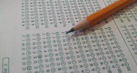 a pencil laying down on a bubble-in answer sheet for a test