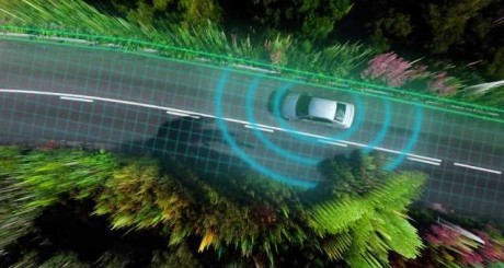 a graphic of a car driving down the road with several blue concentric rings signifying data emitting from it