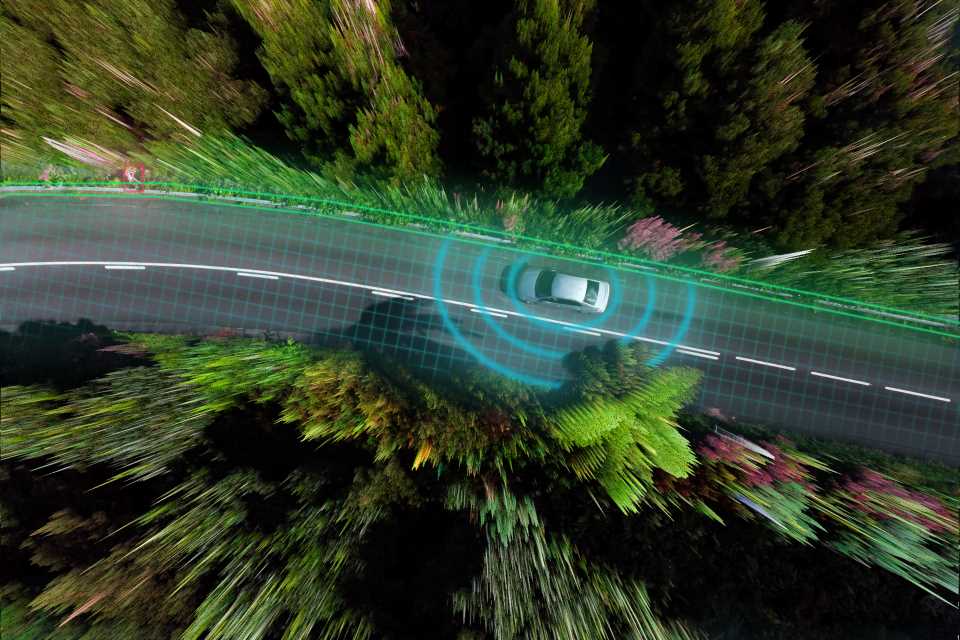 a car driving down a windy road with blue rings emitting from it that represent driving information being delivered